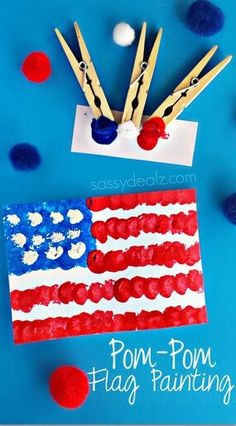 an american flag made out of popsicle sticks with pom - poms around it