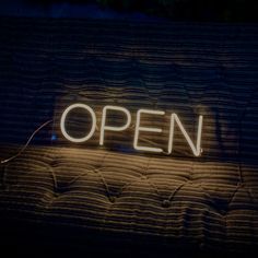 an open sign lit up in the dark