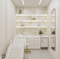 the interior of a salon with white chairs and gold trimmings on the walls