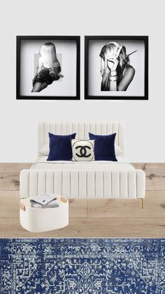 two black and white pictures hang above a bed in a room with blue rugs