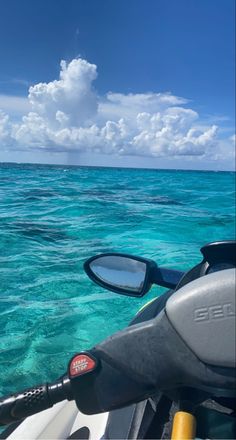 the view from inside a boat looking out at the ocean and clouds in the sky