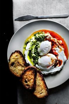 a white plate topped with eggs and bread