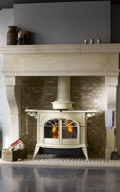 an old fashioned stove in the middle of a room