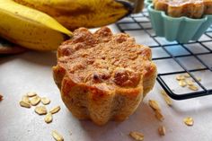 a muffin sitting on top of a table next to some bananas and other food