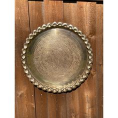 a metal plate sitting on top of a wooden fence