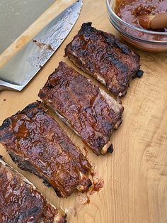 some ribs are sitting on a cutting board