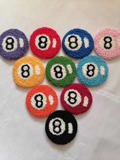 eight ball pool markers laid out on top of a white cloth covered table with the number eight