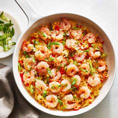 a white bowl filled with rice and shrimp