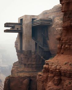 a very tall building sitting on the side of a cliff