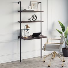 a desk with a laptop on it next to a chair and potted plant in the corner