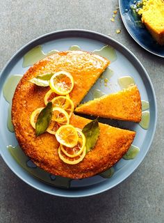 there is a cake with lemon slices on the plate next to another piece of cake