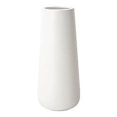 a white vase sitting on top of a table