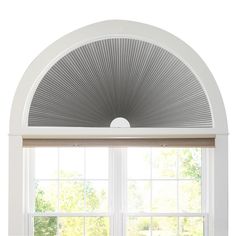 an arched window in a white room