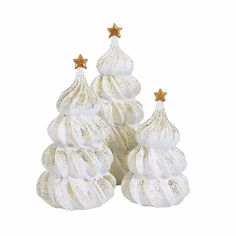 three small white christmas trees with gold stars on top and two smaller ones in the middle