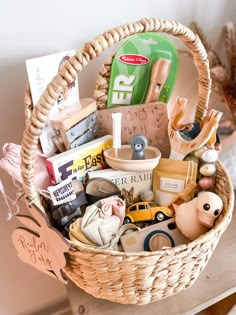 a wicker basket filled with lots of toys and other items on top of a table