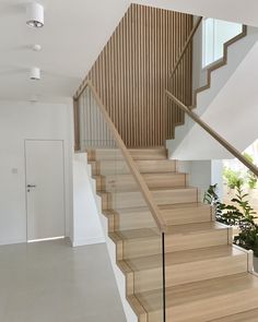 the stairs are made of wood and have glass balconies