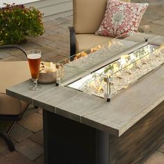 an outdoor fire pit sitting on top of a patio