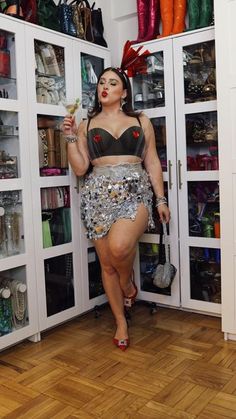 a woman standing in front of a closet full of shoes