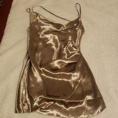 New With Tags. The Fabric Has Minor Snags But They Are Barely Noticeable. Straps Are Not Adjustable. It Has A Draped Front And A Low Back. The Color Is Metallic I Think Silver Or Gold. I'm Not Certain. Buy As Is. Measurements Are Approximate. Color May Vary Due To Lighting. Ask For More Pics/ Vids If Needed To Help You Decide If This Is The Right Purchase For You. Not Responsible For The Fit Gold Mini Dress Aesthetic, Metallic Satin Mini Dress For Evening, Metallic Satin Cocktail Dress, Metallic Sheen Dress For Night Out, Silver Satin Mini Dress For Night Out, Metallic Sleeveless Mini Dress For Formal Occasions, Metallic Sleeveless Mini Dress For Formal Events, Metallic Mini Dress For Summer Formal Events, Metallic Mini Dress For Formal Summer Events