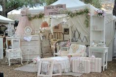 an old fashioned furniture store is set up in the woods for sale with pink and white decor