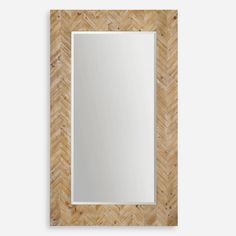 a mirror that is sitting on top of a wooden frame with a chevron pattern