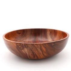 a wooden bowl sitting on top of a white surface