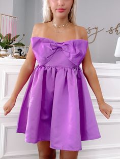 Meet the Regal Ribbon Bow Dress from Sassy Shortcake! This vibrant purple dress features a charming bow and a flattering strapless design. The elegant, soft satin fabric and smocked back provide both comfort and style. Perfect for any special occasion, this dress will make you stand out in a crowd. fit: stretchy fit, runs a bit big (model wearing a size small) content: 100% polyester care: hand wash cold Satin Purple Dress, Sassy Shortcake, Patriotic Dresses, Purple Bow, Purple Bows, Bow Dress, Vibrant Purple, Medium Purple, Ribbon Bow