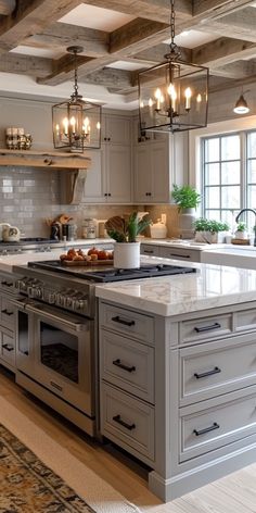 a large kitchen with an island in the middle and lots of lights hanging from the ceiling