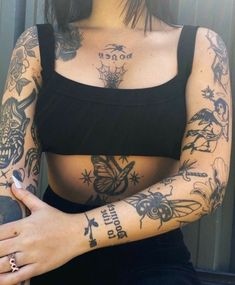 a woman with tattoos on her arm and chest holding a skateboard in her hand