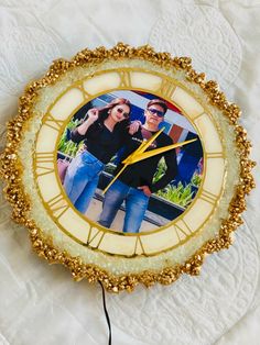 a clock with an image of a man and woman on it's face is shown