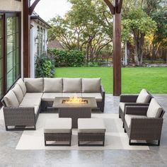 an outdoor patio with furniture and fire pit