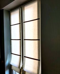 an open window with blinds in the corner