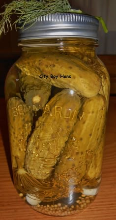 a jar filled with pickles sitting on top of a wooden table