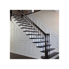 a set of stairs leading up to the second floor in a house with white walls