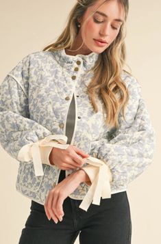 Floral quilted jacket with ribbon detail. - Stand collar - Snap button closure - Contrast binding trim - Drop shoulder long balloon sleeves - Tying ribbon detail on cuffs - Patch pockets - Lined Black Dress Accessories, Party Jackets, Long Balloons, Long Sleeves Jacket, Outdoor Wear, Romper Pants, Balloon Sleeves, Quilted Jacket, Denim Shop