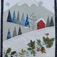 a quilted wall hanging with trees, birds and a red barn in the background