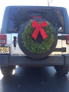 a christmas wreath on the back of a jeep