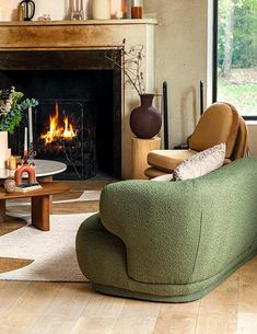 a living room filled with furniture and a fire place next to a large glass window