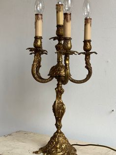 an antique brass candelabra with four candles