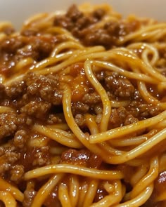 spaghetti with meat and sauce in a white bowl