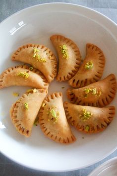 some food is on a white plate and it looks like they have wontons in them