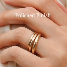 a woman's hand with two gold rings on her left and the words polished finish