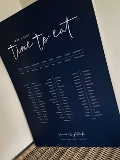 a table plan sitting on top of a wicker basket next to a white wall