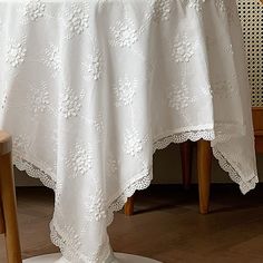 a white table cloth on top of a wooden chair