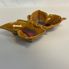 two yellow bowls sitting on top of a white table