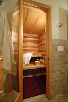 a wooden sauna in a bathroom next to a shower