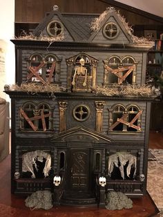 a black doll house with lots of decorations on it