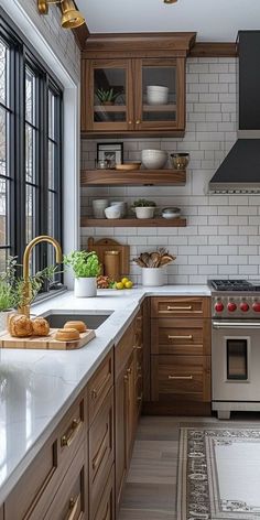 a kitchen with wooden cabinets and stainless steel appliances, along with white counter tops that match the wood flooring