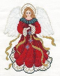 a cross stitched angel with red dress and gold trim