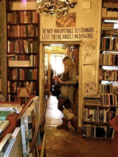 a woman standing in the doorway of a book store